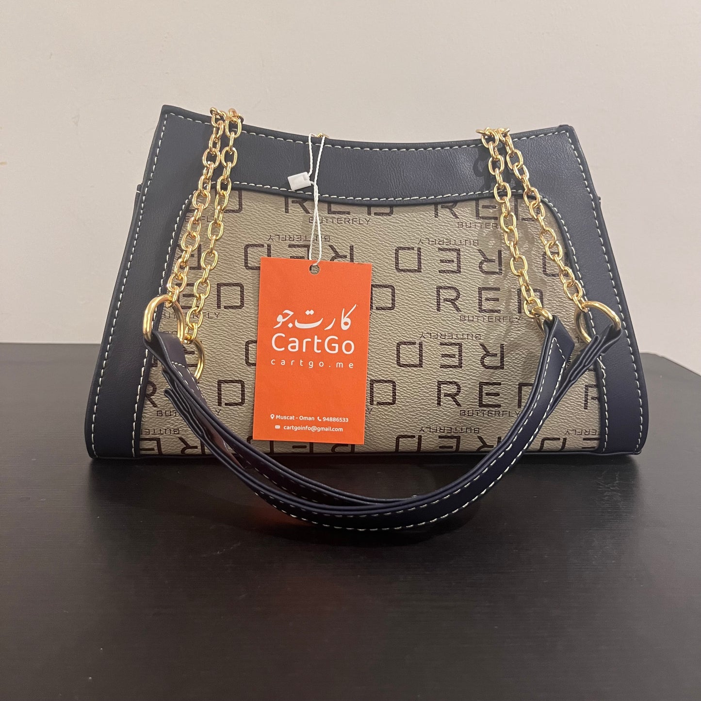 حقيبة لون كحلي بنمط أحرف Monogram patterned navy blue color handbag