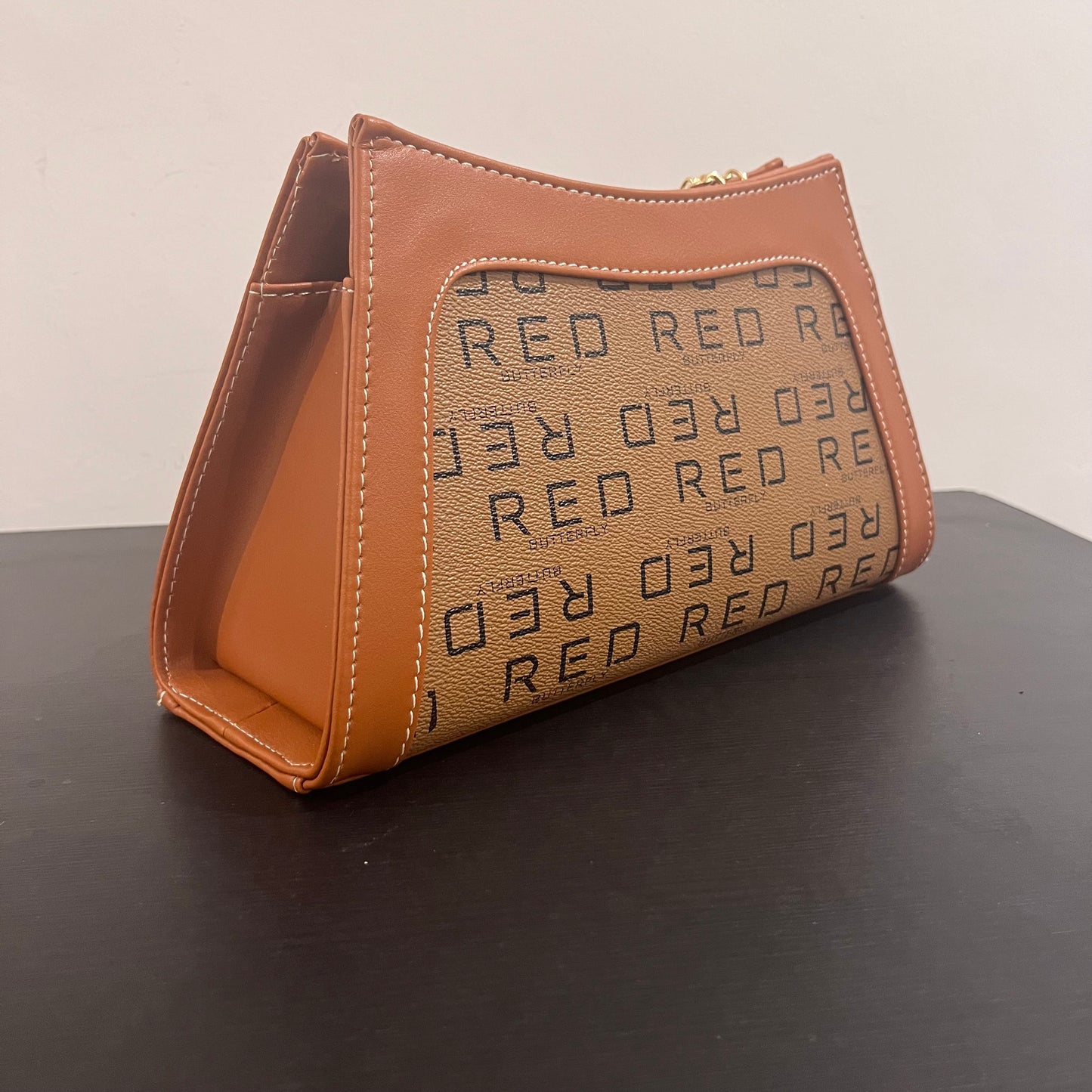 حقيبة لون بني بنمط أحرف Monogram patterned brown color handbag