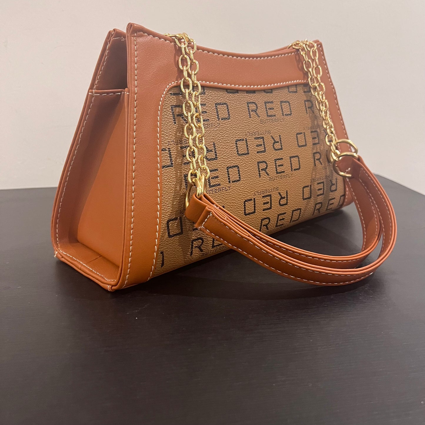 حقيبة لون بني بنمط أحرف Monogram patterned brown color handbag