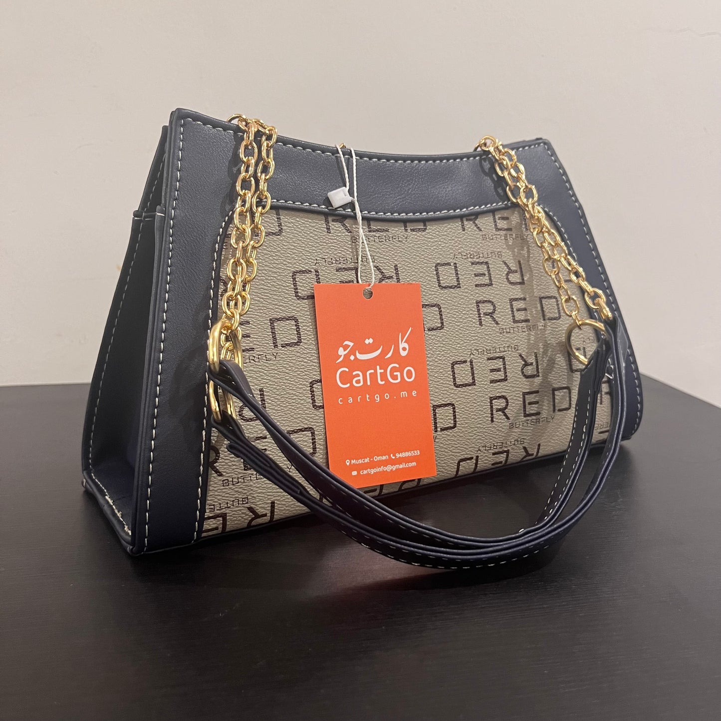 حقيبة لون كحلي بنمط أحرف Monogram patterned navy blue color handbag