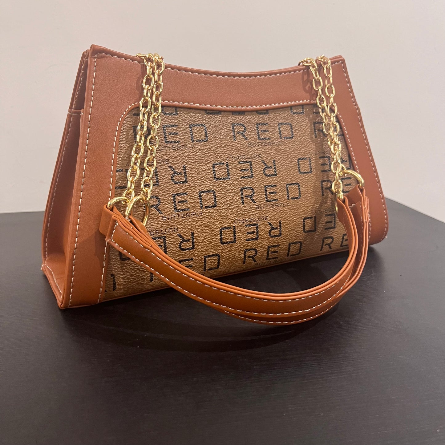 حقيبة لون بني بنمط أحرف Monogram patterned brown color handbag