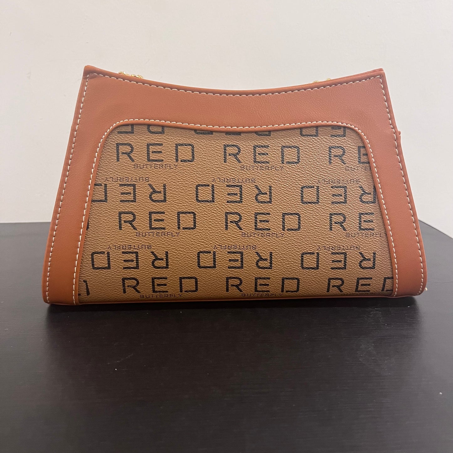 حقيبة لون بني بنمط أحرف Monogram patterned brown color handbag